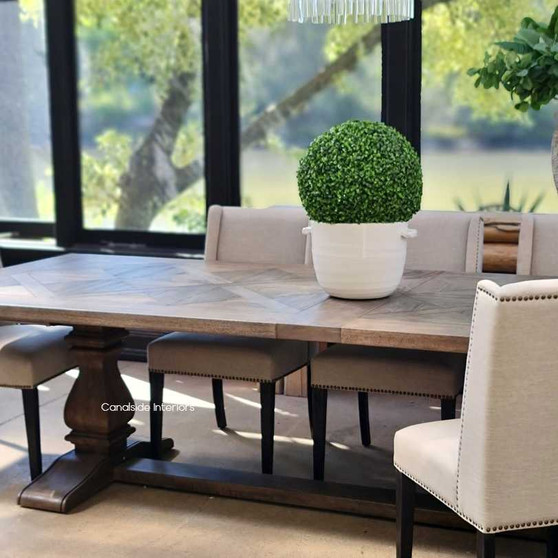 Angled perspective of the dining table, emphasizing its timeless trestle base and the sophistication it adds to any dining space.