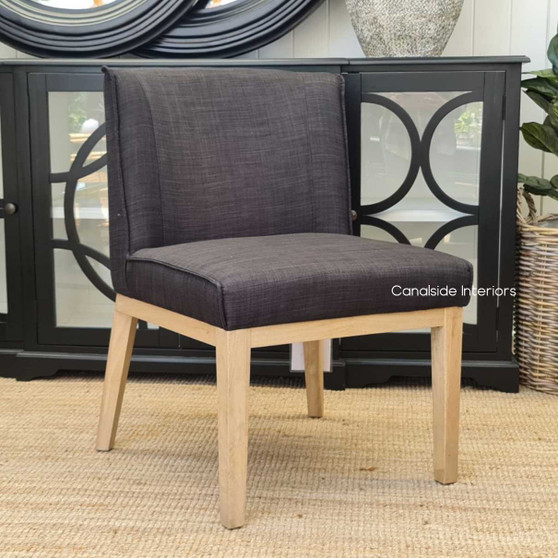 The Norris Dining Chair in Charcoal Linen with Natural Legs offers a modern yet timeless look for any dining room - Canalside Interiors.