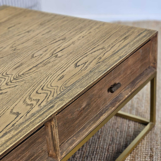 The St Lucia Coffee Table, with its weathered oak finish and elegant gold base, adds a touch of Plantation elegance to your living room - Canalside Interiors