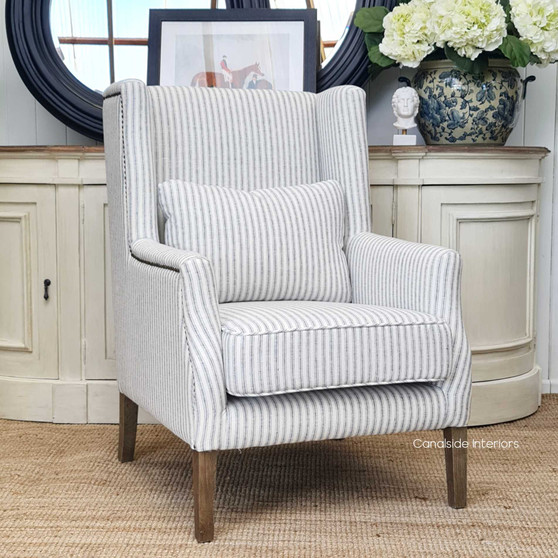View of the Bayview Occasional Wingback Armchair at Canalside Interiors, highlighting its blue striped linen blend upholstery and classic silhouette.