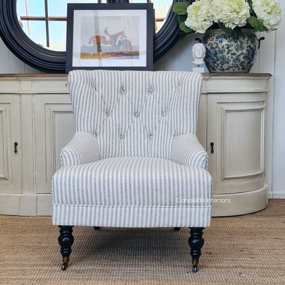 The Ascott armchair in a chic living room setting, serving as both a functional seating option and a sophisticated decorative piece.