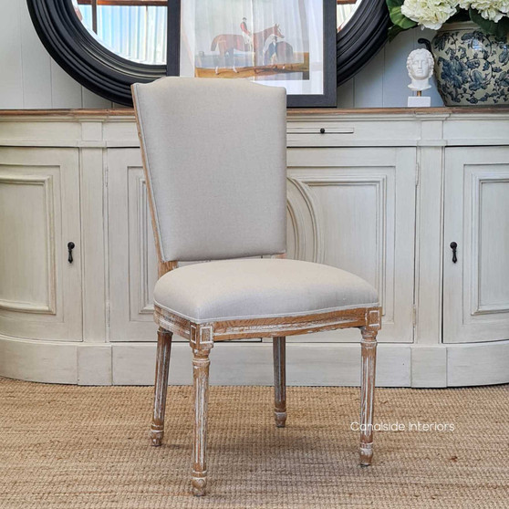 Canalside Interiors' Knightley Dining Chair, with its limewash oak frame and cream linen, adds a touch of Hamptons sophistication to your dining room.