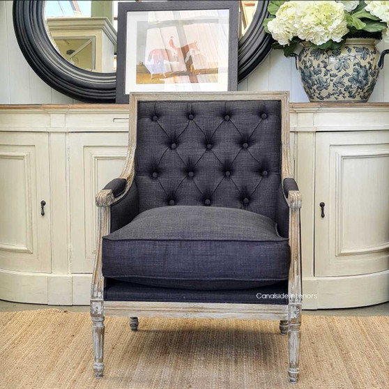 Side angle highlighting the weathered oak frame and hand-crafted carvings - Sophisticated charm for any lounge area.