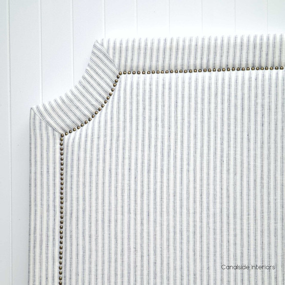 Frontal view of the Mayfair Hamptons Blue Stripe Headboard with gold/brass studs, setting a sophisticated bedroom ambiance.