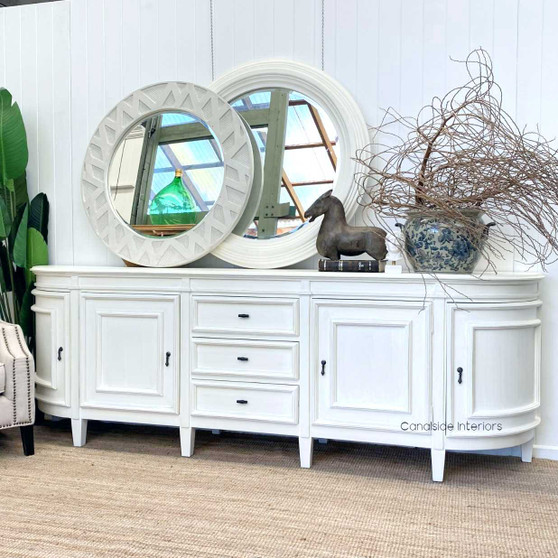 The Francia Grande Sideboard in distressed white commands attention in any living room, combining Canalside Interiors' craftsmanship with a Hamptons aesthetic