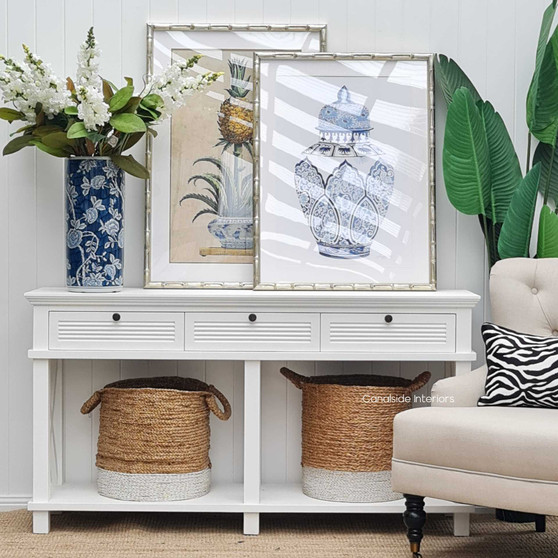 The Catalina Console in Distressed Brushed White presents a serene coastal appeal, ideal for Hamptons-themed living rooms, available at Canalside Interiors