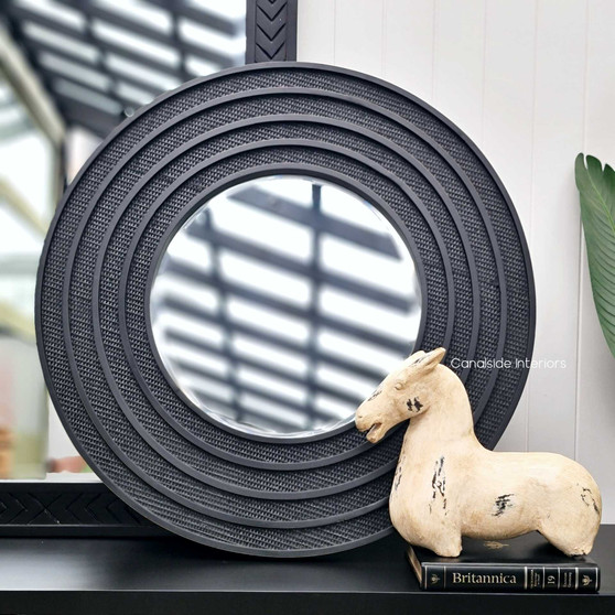 Front view of the Brielle Rattan Round Mirror Small at Canalside Interiors, showcasing its detailed distressed black/charcoal rattan frame.