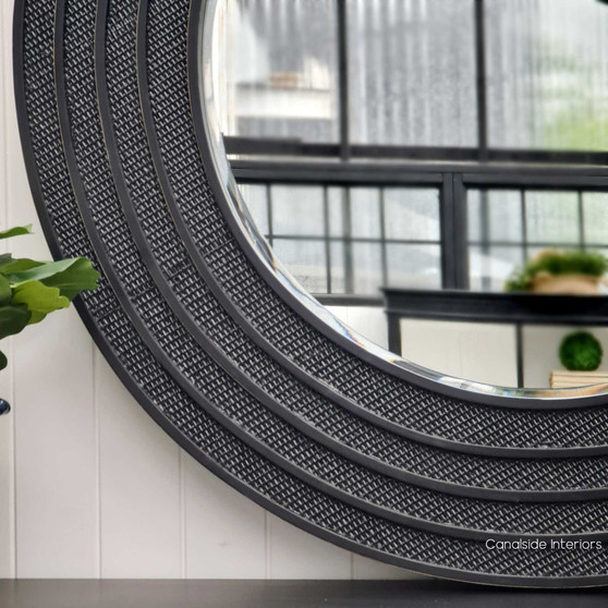 "Frontal view of the Brielle Rattan Round Mirror at Canalside Interiors, highlighting its intricate distressed black/charcoal rattan detailing on a round frame.