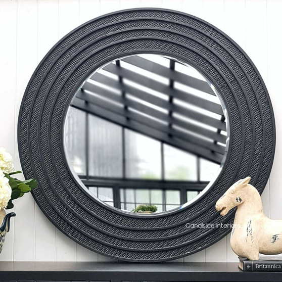 "Frontal view of the Brielle Rattan Round Mirror at Canalside Interiors, highlighting its intricate distressed black/charcoal rattan detailing on a round frame.