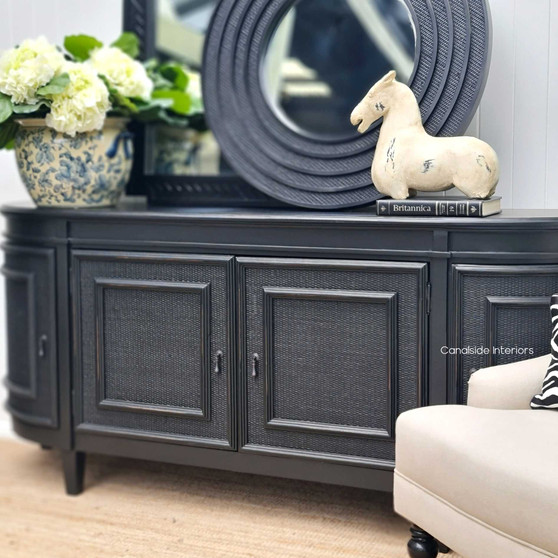 The Francia Rattan Sideboard, with its elegant distressed black/charcoal finish, brings a stately presence to any bedroom, courtesy of Canalside Interiors