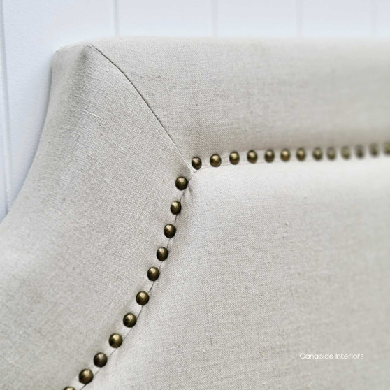 Front view of the Mayfair Hamptons Cream Headboard, showcasing its elegant cream linen upholstery and brass stud detailing.