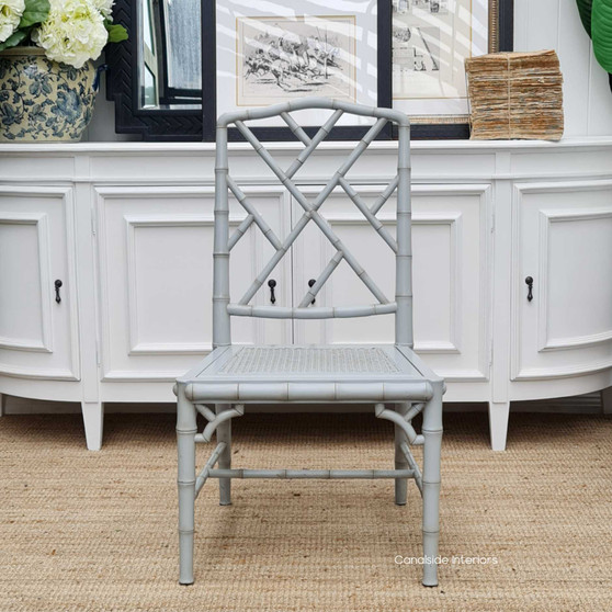 Distressed grey Flamingo Chippendale Chair with intricate rattan work, enhancing a Hamptons-inspired dining room - Canalside Interiors