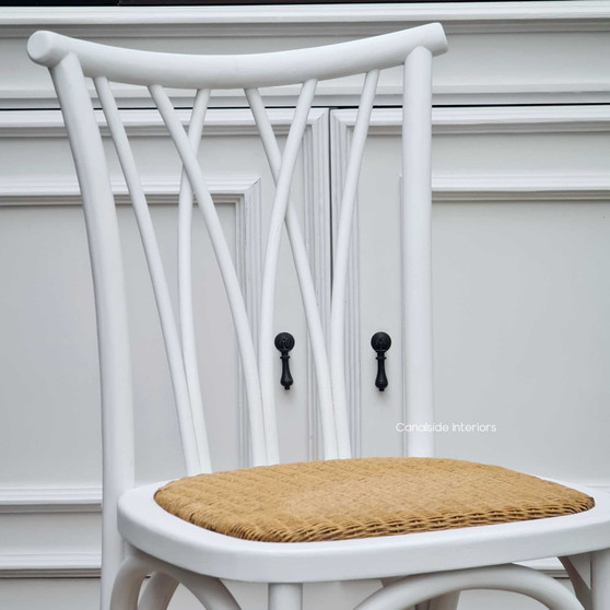 Front view of the Botanica Dining Chair in Distressed White with a natural rattan seat, showcasing its coastal-inspired elegance - Canalside Interiors