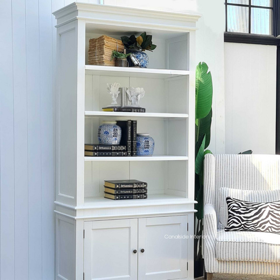 Frontal view of the Grange 2 Door Bookshelf Wall Unit in white with minor distressing, showcasing its spacious shelves - perfect for a Hamptons-style living room