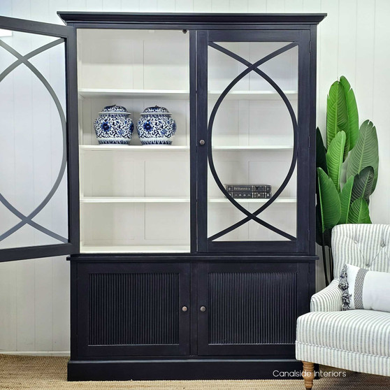 The Riviera Display Cabinet's curved overlay motif adds a touch of lyricism to any coastal-inspired living room