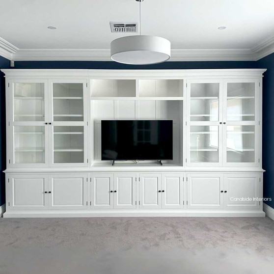 Elegant custom-made Casement Wall Unit in a living room with TV, featuring ample storage and high-quality materials for a sophisticated, organised look.