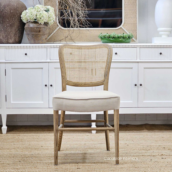 Angled profile of the Noda Oak Rattan Dining Chair, displaying its balanced proportions and seamless blend of oak and rattan materials.