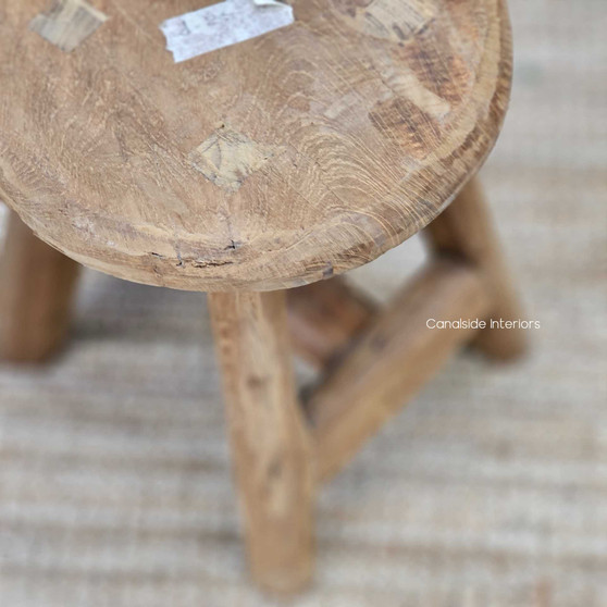 Front view of the lower Vintage Teak Round Stool, highlighting its compact proportions and rich, weathered teak finish.
