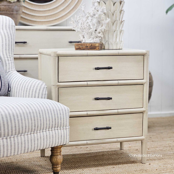 Front view of the Lalise 3-Drawer Bedside Table, showcasing its bamboo-inspired carved wood detailing and distressed stone finish.