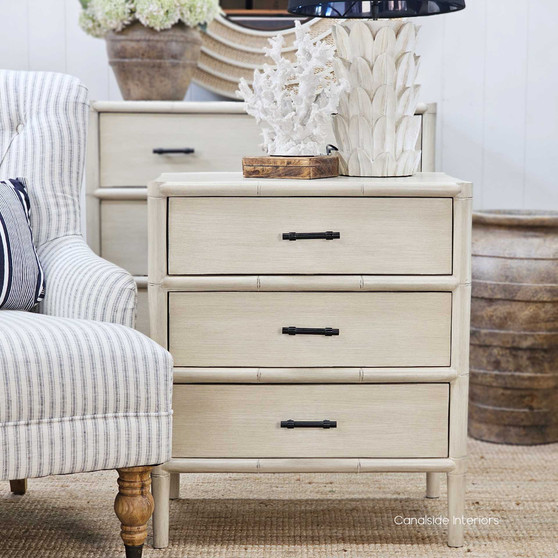 Front view of the Lalise 3-Drawer Bedside Table, showcasing its bamboo-inspired carved wood detailing and distressed stone finish.