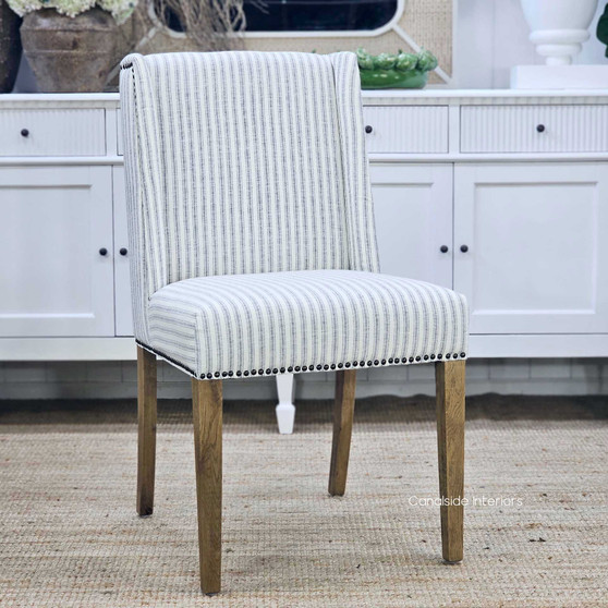 Angled front view of the Leclerc Chair, highlighting its elegant curves and classic tailored shape.