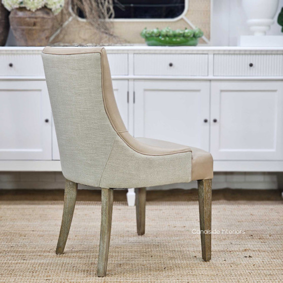 Angled front view of the Aston Dining Chair, showing the gentle curves and mixed-material design.