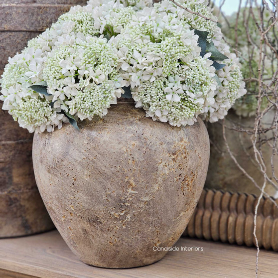 Close-up of the Noema Pot Vessel's weathered terracotta surface, showcasing its raw clay texture and earthy patina.