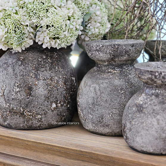 Styled vignette featuring all three Malara pots, paired with rustic decor and soft botanicals.