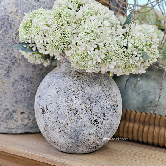 Styled shot of the Elaya vessel filled with white blooms, highlighting the full rounded form and organic texture.