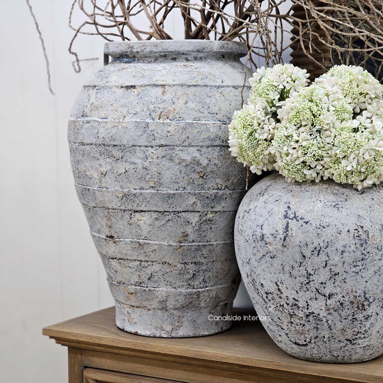 Full view of the Ravena planter styled beside the Elaya pot, highlighting its oversized scale and earthy stonewashed patina.