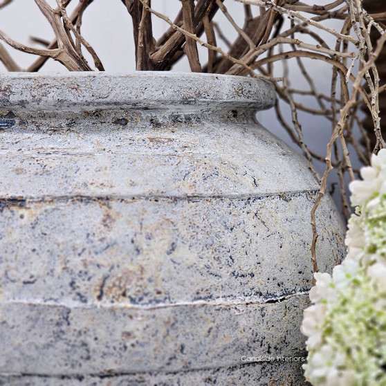 Full view of the Ravena planter styled beside the Elaya pot, highlighting its oversized scale and earthy stonewashed patina.