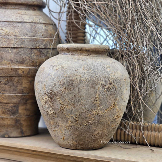 Angled view of the Tala Pot Vessel in aged rustic finish showing its rounded form and textured surface.