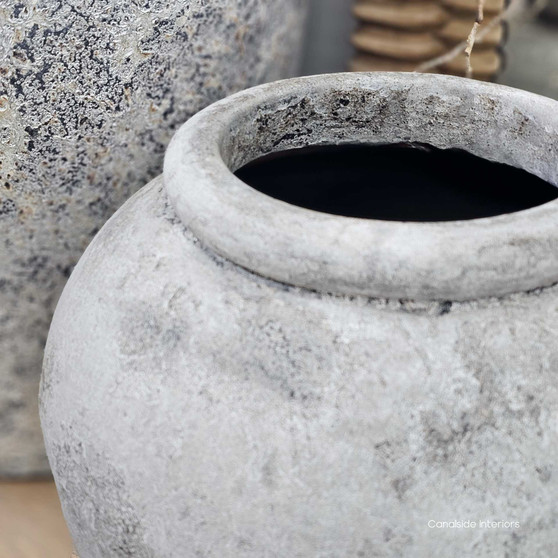 Styled scene featuring the Tala Pot Vessel in smooth rustic stone stylewash with natural greenery.