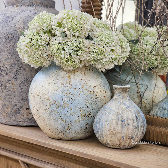 Angled view of the Ismara Pot Vessel in rustic sky finish showcasing its rounded silhouette and soft sky toned patina.