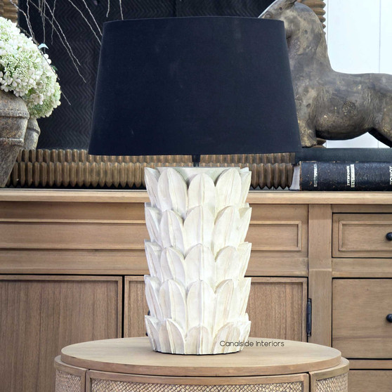 Foliole distressed white hand-carved wooden table lamp with black shade on round side table