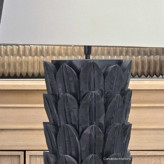 Foliole distressed black hand-carved wooden table lamp with taupe shade on round table