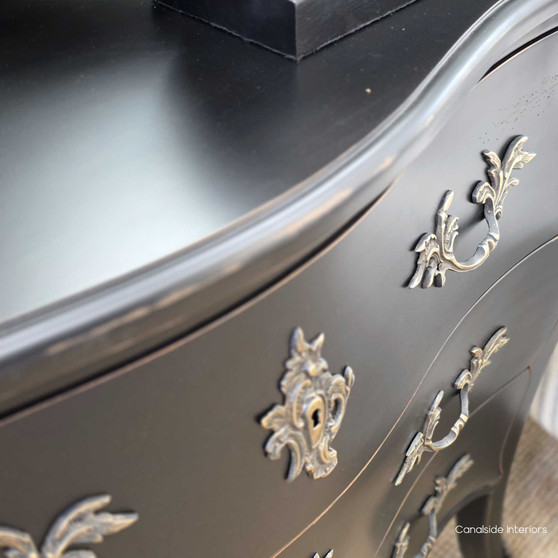 Shot of the chest styled in a hallway with vintage décor, adding bold colour and personality.