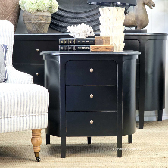 Front view of Creemore 3 Drawer Bedside in Black, showcasing its smooth curved silhouette and deep black painted finish
