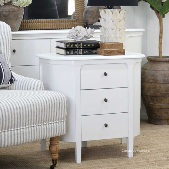 Straight view of the Creemore 3 Drawer Bedside in White, showcasing its curved silhouette, smooth painted finish and simple round hardware.