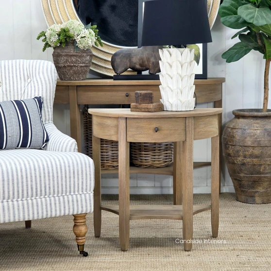 Luna Demilune Side Table with Drawer featuring a natural timber finish, curved tabletop and lower storage shelf.