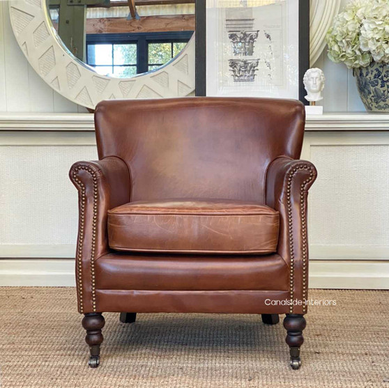 The Doctus Aged Leather Armchair exudes classical elegance, perfect for a cozy nook in your Hamptons-style bedroom - Canalside Interiors
