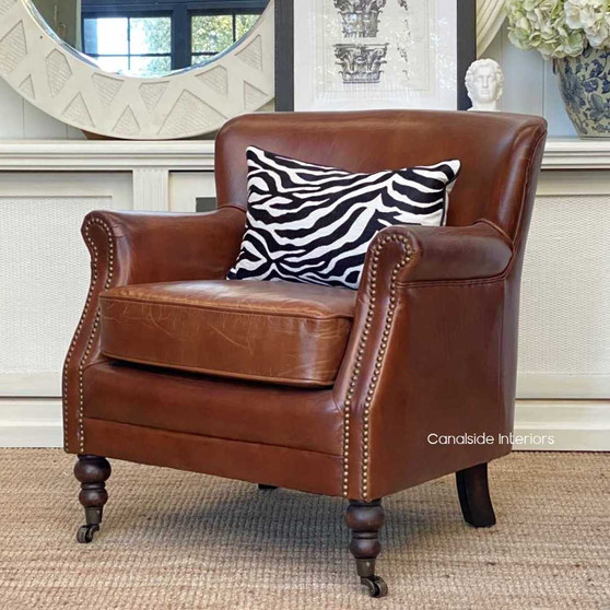 The Doctus Aged Leather Armchair exudes classical elegance, perfect for a cozy nook in your Hamptons-style bedroom - Canalside Interiors