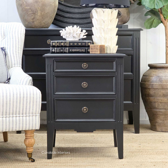 Angled shot of the black Peninsula bedside table highlighting the smooth satin finish and refined proportions.