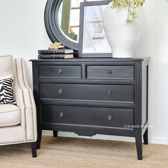 Frontal view of the Peninsula 4 Drawer Chest in black, showcasing its understated charm and spacious storage.