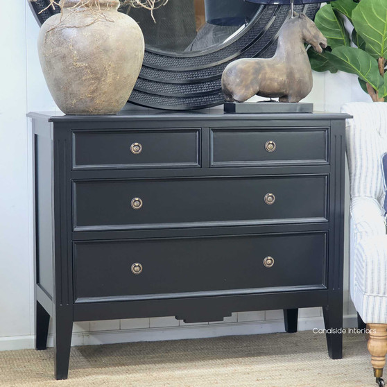 Three-quarter angle of the Peninsula chest in black styled with modern décor accents.