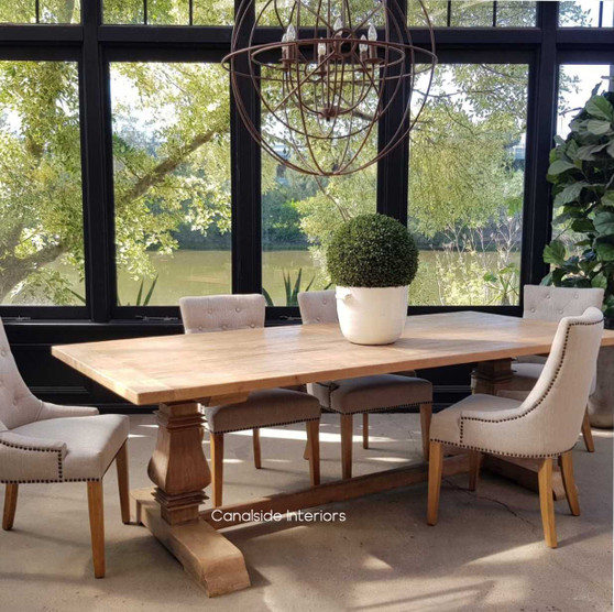 Front view of the Artisan Dining Table at Canalside Interiors, showcasing its recycled timber construction and hand-carved pedestal legs.