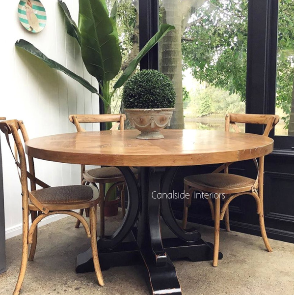  View of the Artisan Parquetry Top Round Dining Table at Canalside Interiors, showcasing its recycled timber and elegant parquetry top.