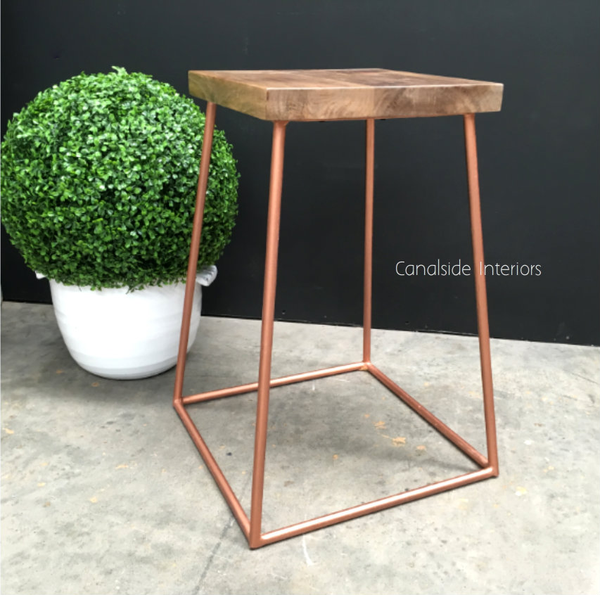 Angled shot highlighting the stool's sleek lines and distressed finish, adding a touch of elegance to any Hamptons or coastal-themed bar area.