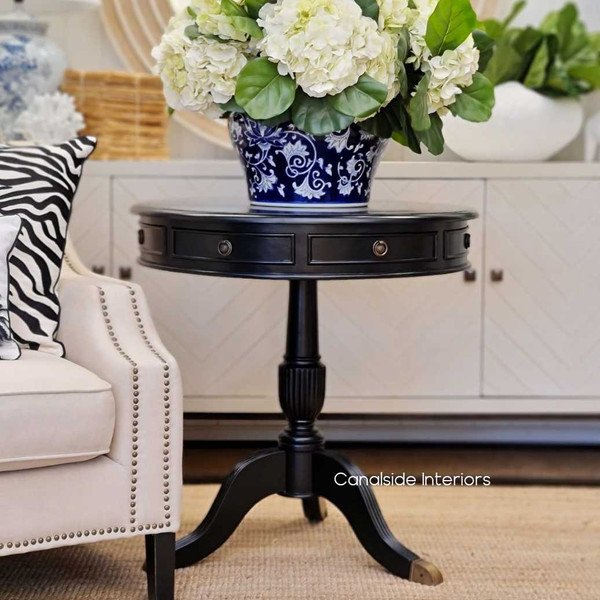 The Cobble Hill Large Round Table in a classic black finish from Canalside Interiors offers a modern take on timeless design, ideal for creating a welcoming entry in your front foyer