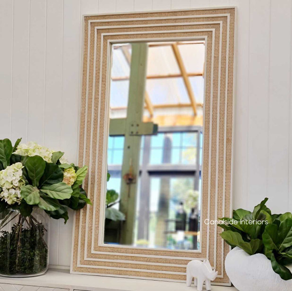 Side perspective of the rectangular mirror, highlighting the depth and texture of the rattan against the distressed stone.